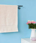 Farmhouse Style Matte Black Wrought Iron Towel Holder, Wall Mounted Towel Bar For Bathroom And Kitchen with a white towel