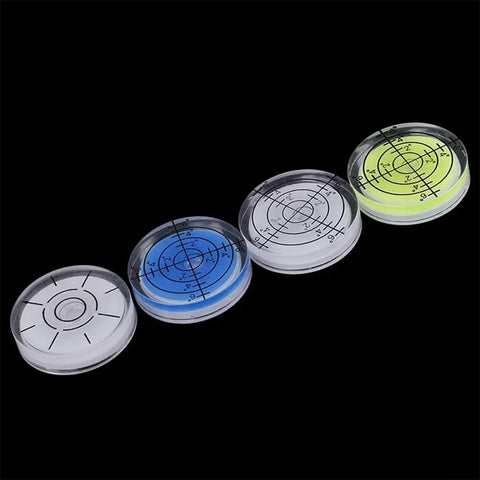Four 32mm for acrylic Bubble Level Round Circular for spirit Gauge(1) in clear, blue, white, and yellow colors on a dark background.