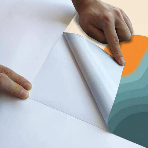 Peel And Stick 3D Retro Sunset Landscape Wall Mural In Mid Century Graphic Style Removable Wallpaper being applied to a wall.
