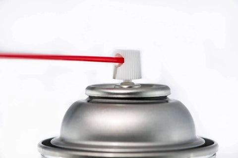 A close-up of a spray can nozzle of Your Go To Dry Graphite Film Spray Anticorrosive Lubricant For Metal Surfaces with a red tube nozzle