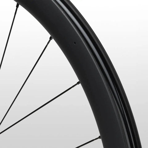 Close-up of 105 Rs710 C46 Carbon Road Wheelset Tubeless 700c Hooked Rim 46mm Deep showing black carbon rim and spokes.