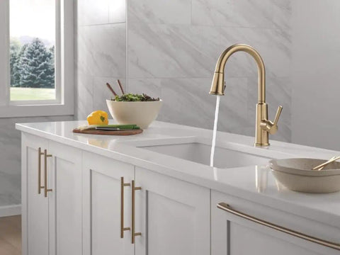 Modern Single Hole Kitchen Faucet With Slick Pull Down Sprayer Brushed Gold Finish, water flowing from spout in stylish kitchen.