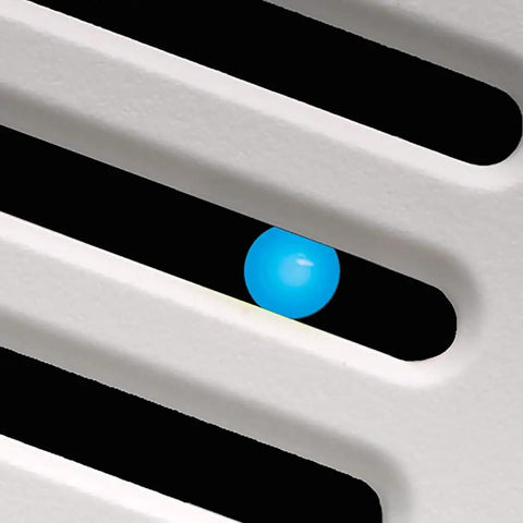 Close-up of Slim SLM70H No Frills Exhaust Bath Fan With Humidity Sensor's blue LED indicator through vent slats.