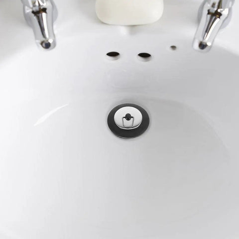 Stainless Steel Seal Rubber Bathtub Drain Plug for Bathrooms positioned in a white sink, designed for effective sealing.