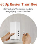 Hands setting up 6 Mesh WiFi System With WiFi 6 AX1800 For Homes Up To 4000 Sq Ft 2 Pack with Ethernet cable.