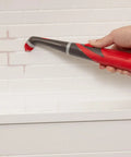 Using attachable grout head for cordless power scrubber on bathroom tile grout lines, hard-to-reach spaces