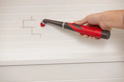 Using attachable grout head for cordless power scrubber on bathroom tile grout lines, hard-to-reach spaces