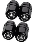Four black Mercedes Benz Tire Valve Caps with emblem, part of the Mercedes Benz Tire Valve Caps And Leather Keychain Set, Four Pack Dust Caps For Car Keys And Tires, Dope Iron Keyring With Premium Leather, Fits CLA CLK GLE GLS AMG Series And More Car Accessories.