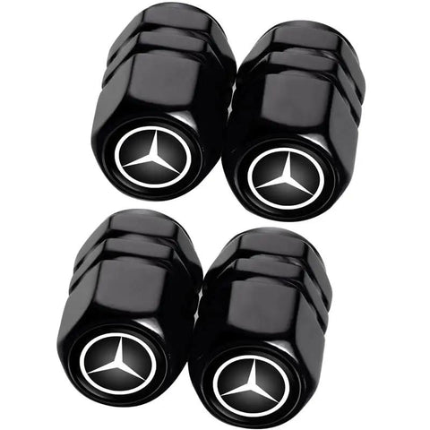 Four black Mercedes Benz Tire Valve Caps with emblem, part of the Mercedes Benz Tire Valve Caps And Leather Keychain Set, Four Pack Dust Caps For Car Keys And Tires, Dope Iron Keyring With Premium Leather, Fits CLA CLK GLE GLS AMG Series And More Car Accessories.