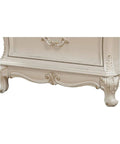 Bottom detail of Timeless Tradition Nightstand With Granite Top In Pearl White Veneer, featuring ornate wood leg base and carvings.