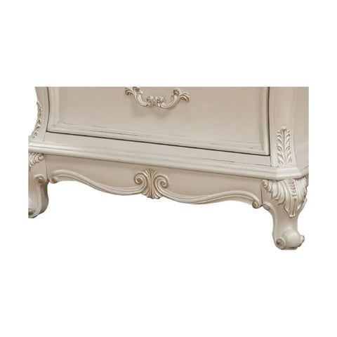 Bottom detail of Timeless Tradition Nightstand With Granite Top In Pearl White Veneer, featuring ornate wood leg base and carvings.