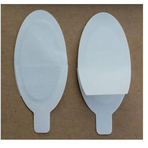 100 Pairs OD7+ Laser Safety Glasses For IPL LED And Microdermabrasion Buttery Soft Disposable Eye Shields on a brown background.