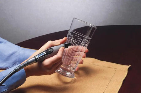 225 Flex Shaft Extension for Rotary Tools used for engraving a glass against a brown cloth background