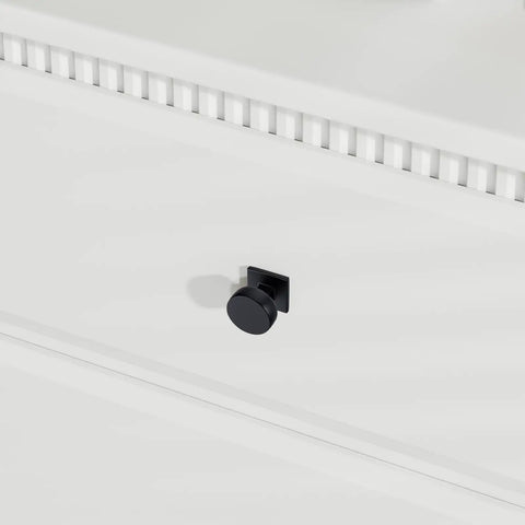 Close-up of round black cabinet knob on drawer, part of 25 Pack Black Cabinet Knobs for Cabinets and Drawers, Square and Round Aluminum Alloy.