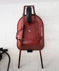 Garage Wall Ladder Hooks 2 Pack, Heavy Duty Wall Mount Hanger in use holding a red wheelbarrow against a white brick wall