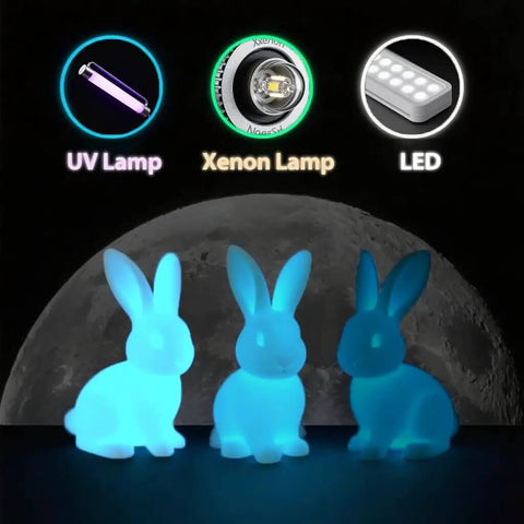 Glow in the dark gradient rainbow 1.75mm PLA filament bunnies illuminated by UV, Xenon, and LED lamps in front of a moon backdrop.