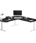 Slick Electric L Shaped Corner Standing Desk With Swift Height Adjustment And Roomy 72 By 72 Inch Workbench, featuring dual monitors and accessories.
