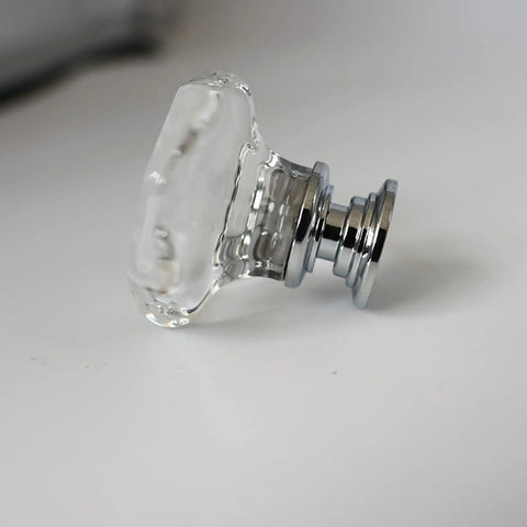 Close-up of a crystal cabinet knob set with glass doorknobs and chrome base, sparkling drawer pull for cabinets and dressers.