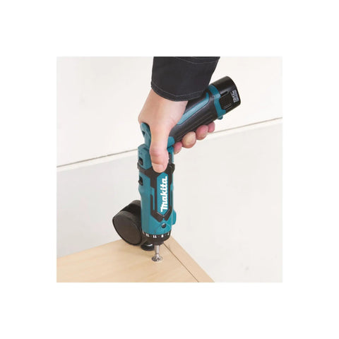 Hand holding Super Compact Cordless Pencil Drill Offering Slick Ratchet Action And 21 Position Torque Control tightening a screw.