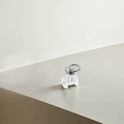 Thirty Pack Of Heavy Duty Double Wheel Curtain Track Rollers on a smooth surface, showcasing a white double wheel design.