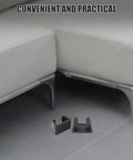 4 Pack Black Plastic Outdoor Furniture Clips For Sofas And Beds with firm grip shown on the floor near a couch.