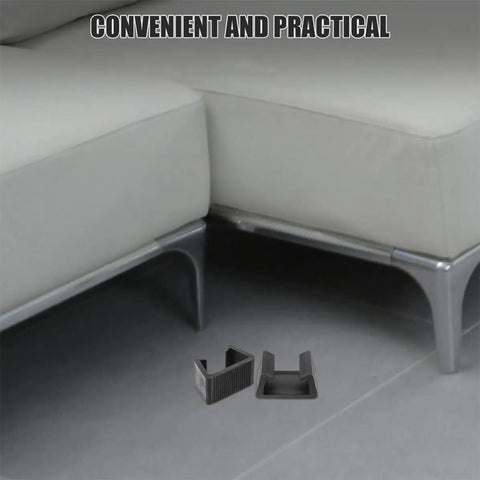 4 Pack Black Plastic Outdoor Furniture Clips For Sofas And Beds with firm grip shown on the floor near a couch.