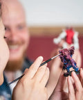 Person painting a fantasy miniature with Speedpaint Plasmatic Bolt 2.0 One Coat Acrylic Paint for tabletop miniatures.