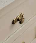 Antique Brass Cabinet Knobs with Industrial Backplates on kitchen drawer, vintage pulls, concealed backplate design for rustic farmhouse vibe.
