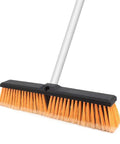 Heavy Duty 18 Inch Push Broom Long Handle Dual Bristle Gear For Concrete Garage Warehouse And Driveway Cleanup Shop Floor Workhorse Weekend Warrior Grime Getter Rig close-up of bristle head and stainless handle.