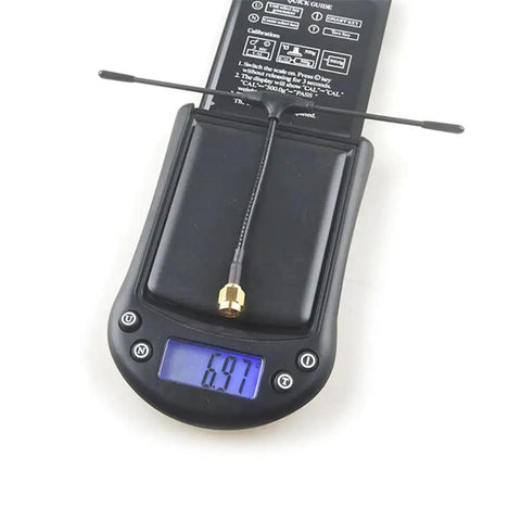 ExpressLRS ES900TX Module And ES900RX Receiver Combo Kit 915MHz antenna weighed on digital scale, showing 6.97 grams