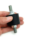 Rock Solid 4 Pack M8 Double Stud Rubber Isolator Mounts Measuring 30X20mm With Zinc Coated Steel And Hex Locknuts in hand.