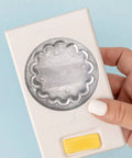 Hand holding a 2.25 Inch Scalloped Circle Punch for Scrapbooks and Card Making, showing large white craft punch design.