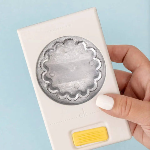 Hand holding a 2.25 Inch Scalloped Circle Punch for Scrapbooks and Card Making, showing large white craft punch design.