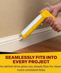 Dripless CR400 contractor caulk gun with yellow cradle applies white caulk along baseboard (29 oz cartridge).