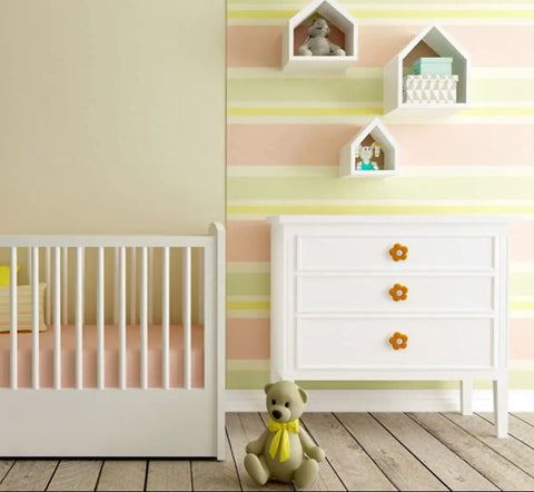 Top Shelf Cartoon Style Soft Grip Rubber Cabinet Knobs And Drawer Pulls For Kids Rooms Featuring Bulletproof Zinc Base Kid Approved Safe Finish And Zero Hassle Bolt Up Setup in a nursery with white dresser and crib.