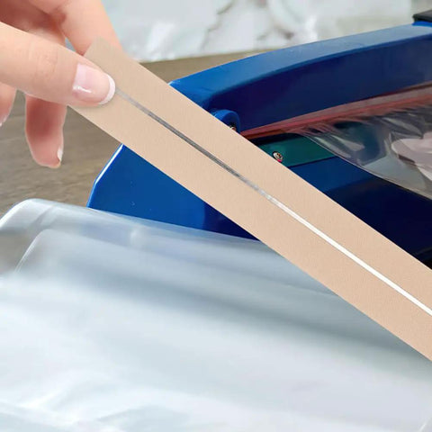Close-up of hand holding 6 Piece Impulse Sealer Heat Wire Element Strips 18 Inch Long 8mm Wide Replacement Heating Seals
