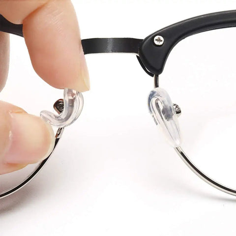 Super Comfy Silicone Airbag Glasses Nose Pads With Hella Soft Metal Support, clear silicone pad being attached to glasses.