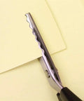 Pinking Shears For Fabrics Pro Grade Multi Purpose Stainless Steel Scissors With Black Handle 18mm Scalloped Serrated Blade For Fabrics Leather Linings Paper And Craft Projects, close-up on paper