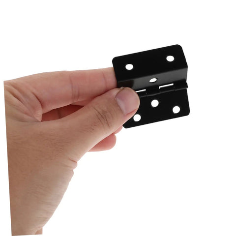 Hand holding three fold iron cabinet door hinges with six hole mounting vintage black chest hinges for decorative cabinets and trunks