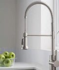 Commercial Style Spot Free Stainless Steel Pre Rinse Kitchen Faucet With Deck Plate And Sprayer in modern kitchen setting.
