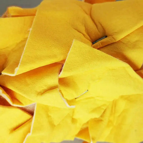 Close-up of non woven embossed cover of Straight Up Solid 7 Inch Texture Paint Roller, showing soft yellow texture.