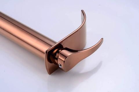 Rose gold waterfall single lever tap, sleek spout design, for modern vessel sinks, close-up view of smooth operation mixer