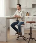 Man sitting on Industrial Retro Farm Tractor Stool Swivel Height Adjustable Bar Stool For Kitchen Counter Copper Finish Cast Iron Frame