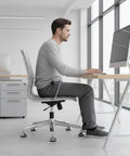 Man using an office chair with 5 Pack 2 Inch Bell Glides For Office Chair Low Profile Caster Replacement for stability.