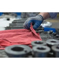 Person using red cotton towel from Heavy Duty White And Red Shop Towels 50 Pack Workhorse Reusable Cotton Rags For Garage Auto Shop Cleaning Lint Free And Highly Absorbent Built To Tackle Grease Oil And Heavy Dirt In Industrial Settings in garage setting.