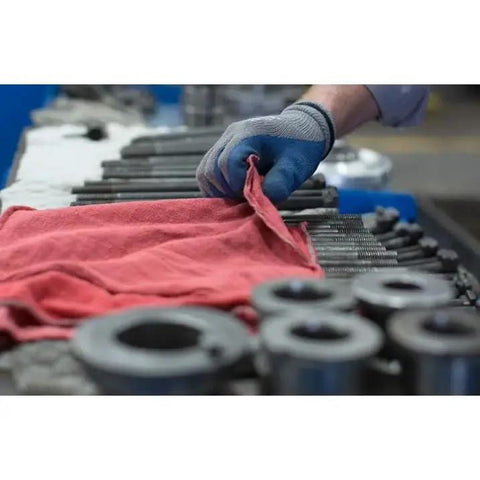 Person using red cotton towel from Heavy Duty White And Red Shop Towels 50 Pack Workhorse Reusable Cotton Rags For Garage Auto Shop Cleaning Lint Free And Highly Absorbent Built To Tackle Grease Oil And Heavy Dirt In Industrial Settings in garage setting.