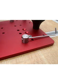 Close-up of a red Heavy Duty Router Table Rail Coping Sled For Cabinet Doors And Drawer Fronts Precision Alignment Tool with screws.