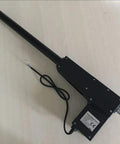 Heavy Duty 12V And 24V Linear Actuator With 20 Inch Stroke And 8000N Load, showing black push rod with wiring on wooden surface