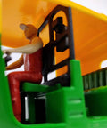 Interior view of Ace Handcrafted Miniature Auto Rickshaw Desk Model sporting vivid yellow and green finish with driver figure.