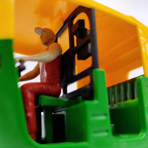 Interior view of Ace Handcrafted Miniature Auto Rickshaw Desk Model sporting vivid yellow and green finish with driver figure.